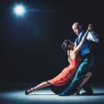Elegancka para tańczy tango w świetle reflektorów na parkiecie